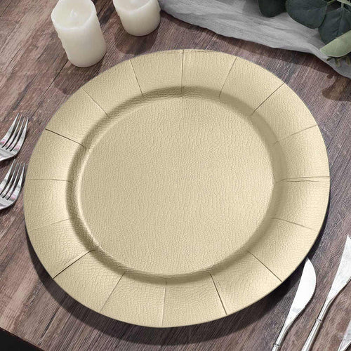 Gold textured serving plate on a wooden table with candles and cutlery.