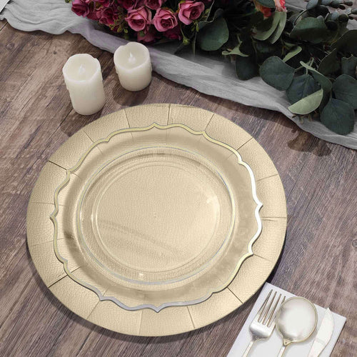 Elegant gold charger plate on rustic wooden table with candles and flowers.