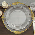 Elegant clear plate with gold and silver accents on dark wood table.