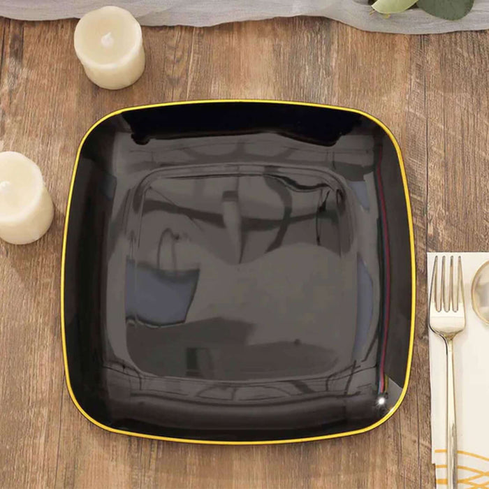 Black square plate with a yellow rim on a wooden table.