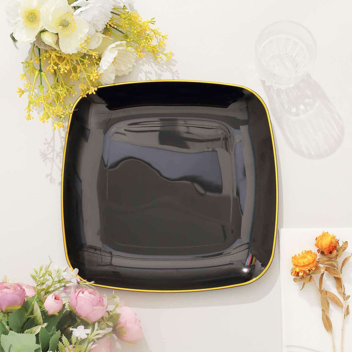 Black square plate with yellow trim, styled with floral decor.