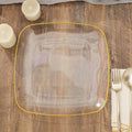 Clear square plate with yellow rim on wooden table.
