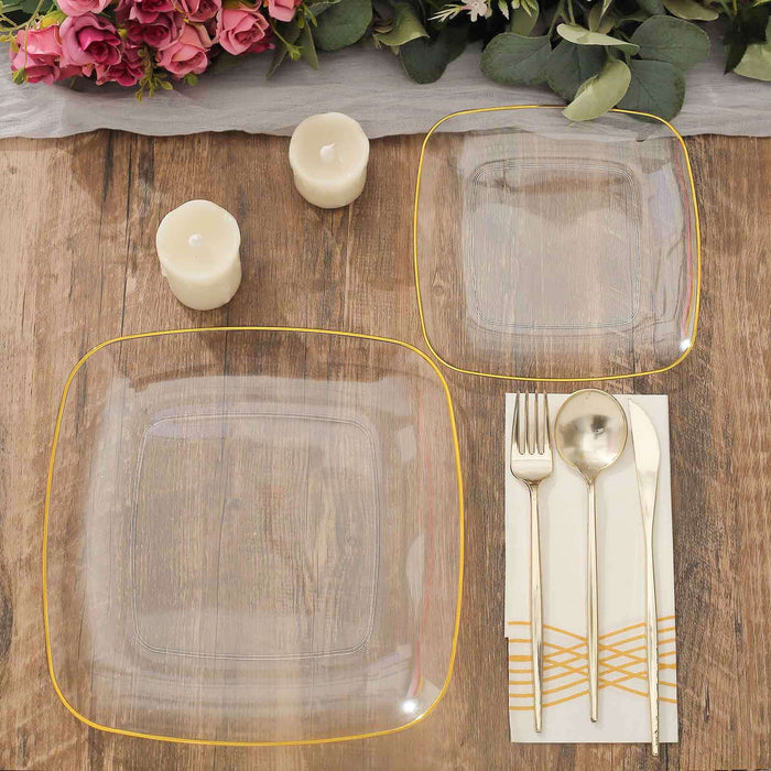 Elegant clear glass plates with gold rim, styled on a rustic wooden table.
