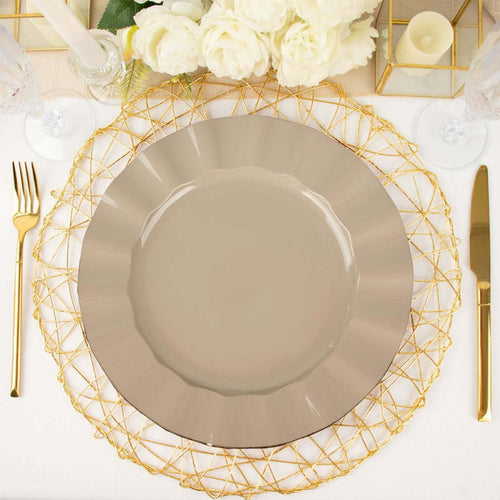 Elegant taupe dinner plate on a gold wire charger with cutlery and flowers.