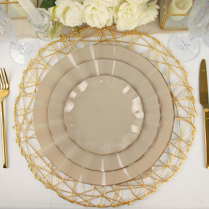 Elegant beige dinner plates set on a gold wire charger with floral decor.