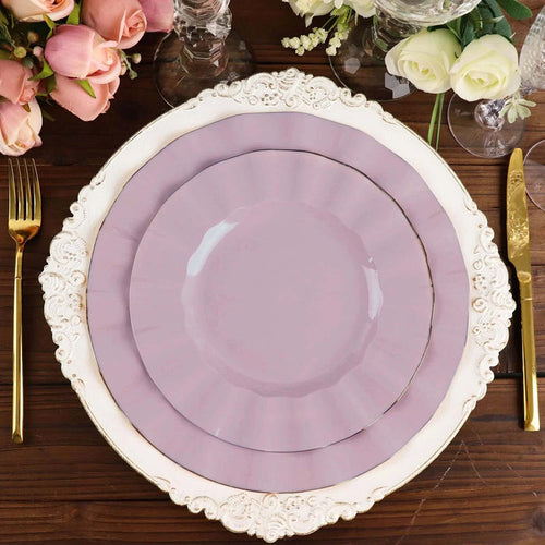 Elegant lilac plates set on a decorative charger with floral arrangements.