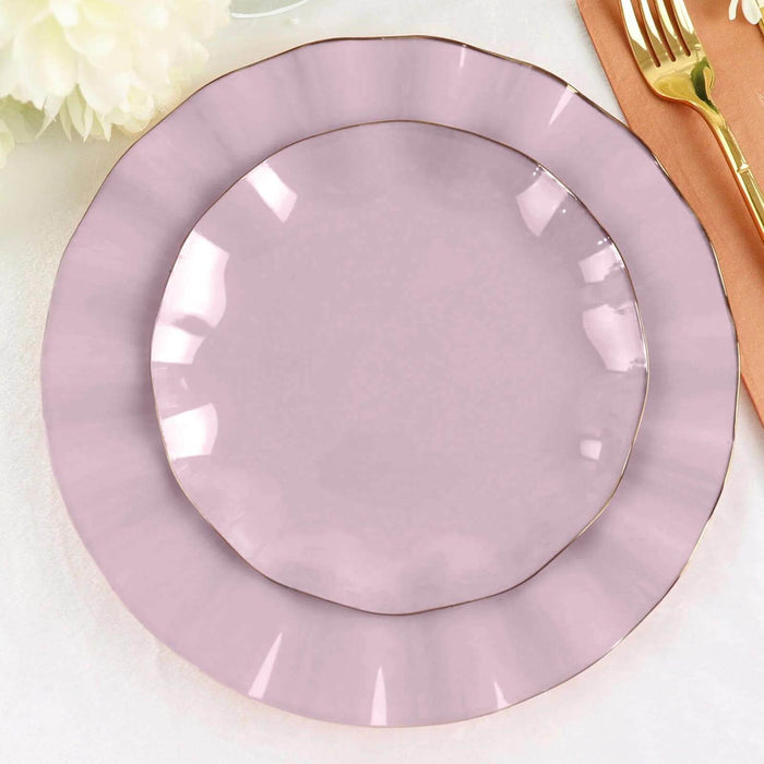 Pink decorative plates with gold trim on a plain background.