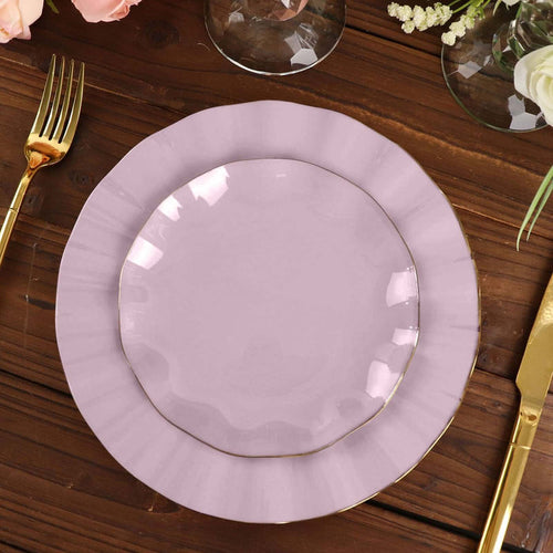 Purple scalloped plate with gold trim on a wooden table setting.