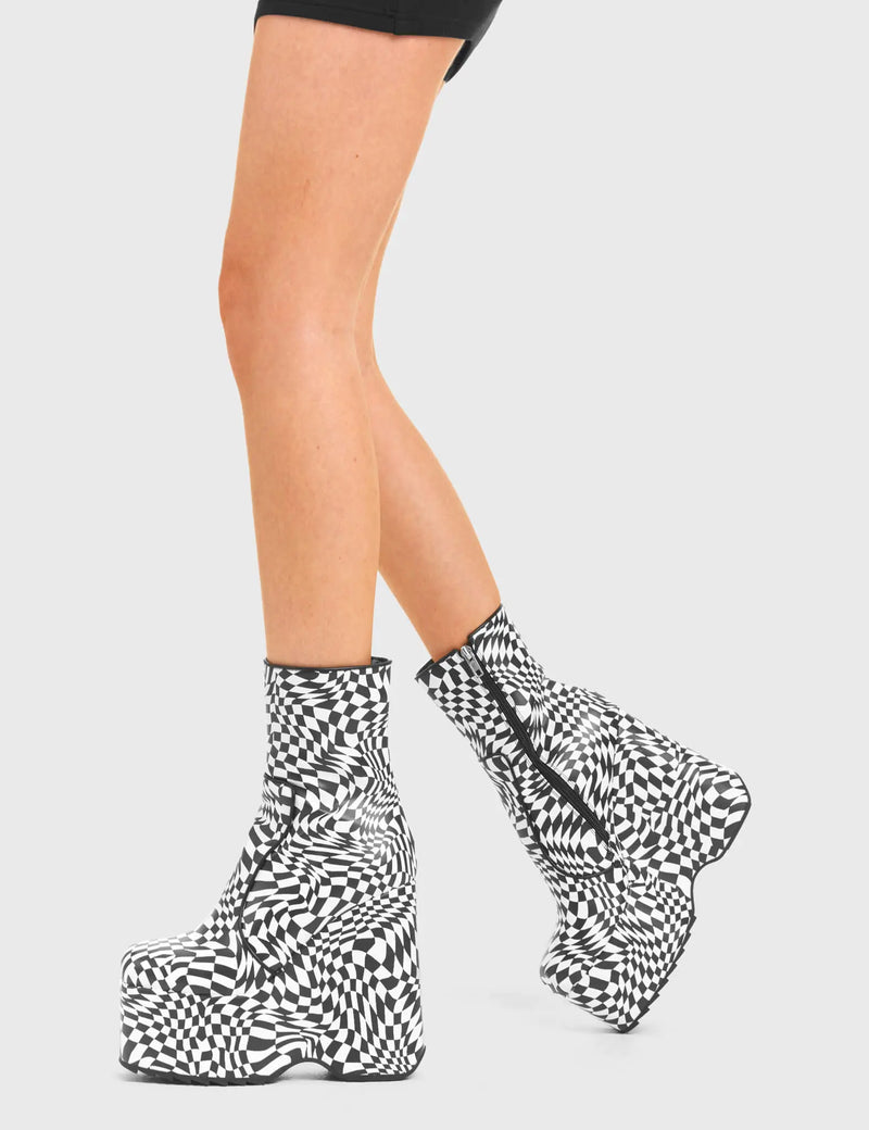 Illusionistic
  
  Aftershock Chunky Platform Ankle Boots in Black and White faux leather. These platform boots feature a black and white check design with a platformed wedge. Made with eco-friendly materials and 100% cruelty-free, these platform boots are as ethical as they are chic.
  
  - Platform Height
  - Fitted feel
  - Black and White check
  - Rounded toe
  - High Heel
  - 100% vegan 
  
  SKU: LMF 3536 - Black White