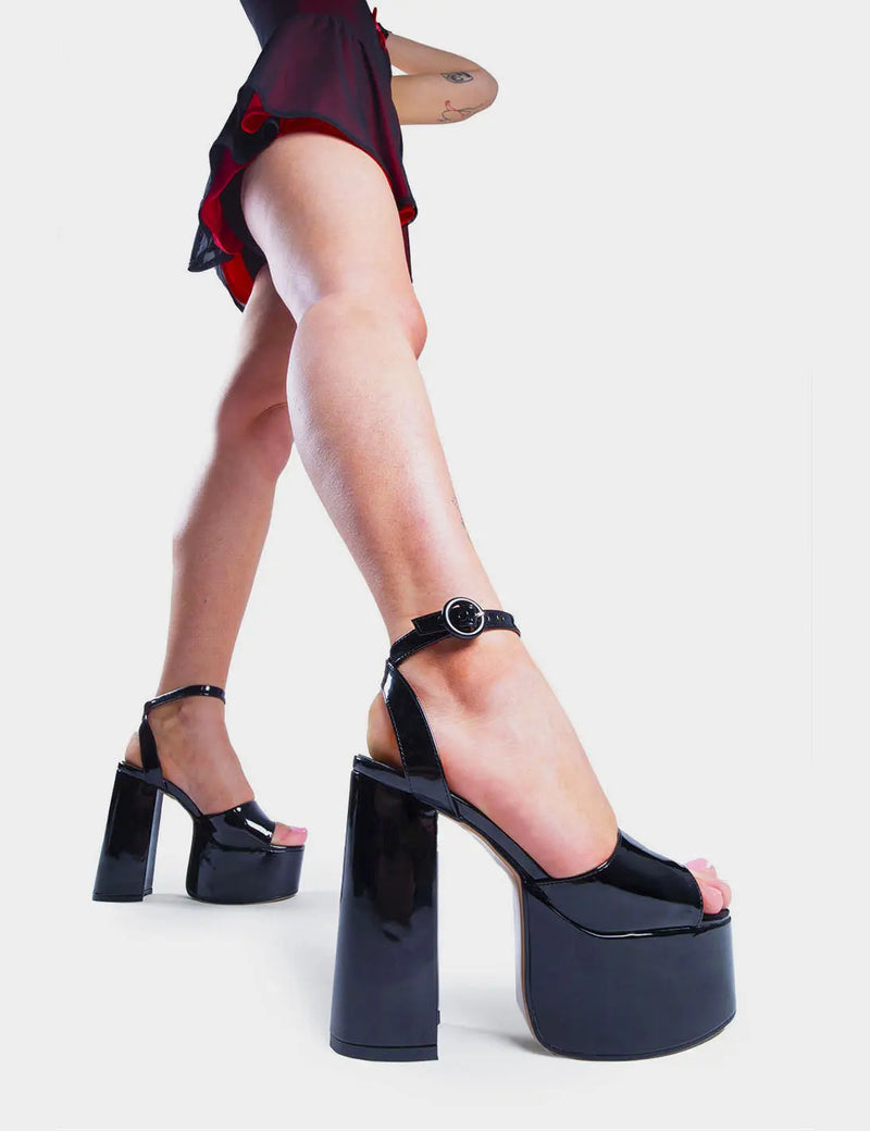 MAKE YOUR STATEMENT 
  
  All For You Platform Sandals in Black Patent. These high heeled vegan Sandals feature an adjustable ankle strap with a Platform sole and high heel, perfect for adding height and glamour to any outfit. Made with eco-friendly materials and 100% cruelty-free.
  
  
  - Platform Height: 2.5 inch
  - Heel Height: 5.5 inch 
  - Open Toe
  - Wrap around ankle strap
  - O shaped buckle and silver eyelets
  - Platform sole
  - Round toe 
  - 100% vegan 
  
  SKU: LMS 104 BLACKPAT