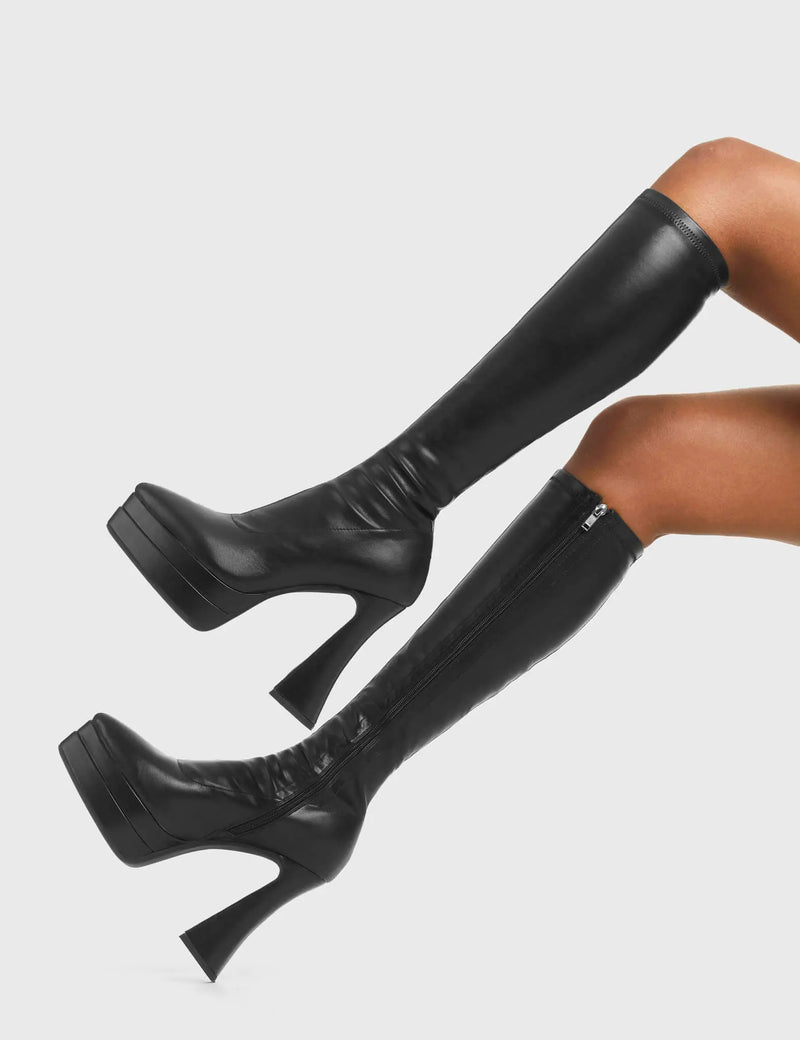 THESE BOOTS ARE MAKE FOR WALKING
  
  Alter Ego Platform Knee High Boots in Black fitted faux leather. These platform boots feature a minimalist look with a flared heel. Made with eco-friendly materials and 100% cruelty-free, these platform boots are as ethical as they are chic.
  
  - Platform Height
  - Fitted feel
  - Flared heel
  - Pointed toe
  - High Heel
  - 100% vegan 
  
  SKU: LMF 3532 - BlackPUStretch