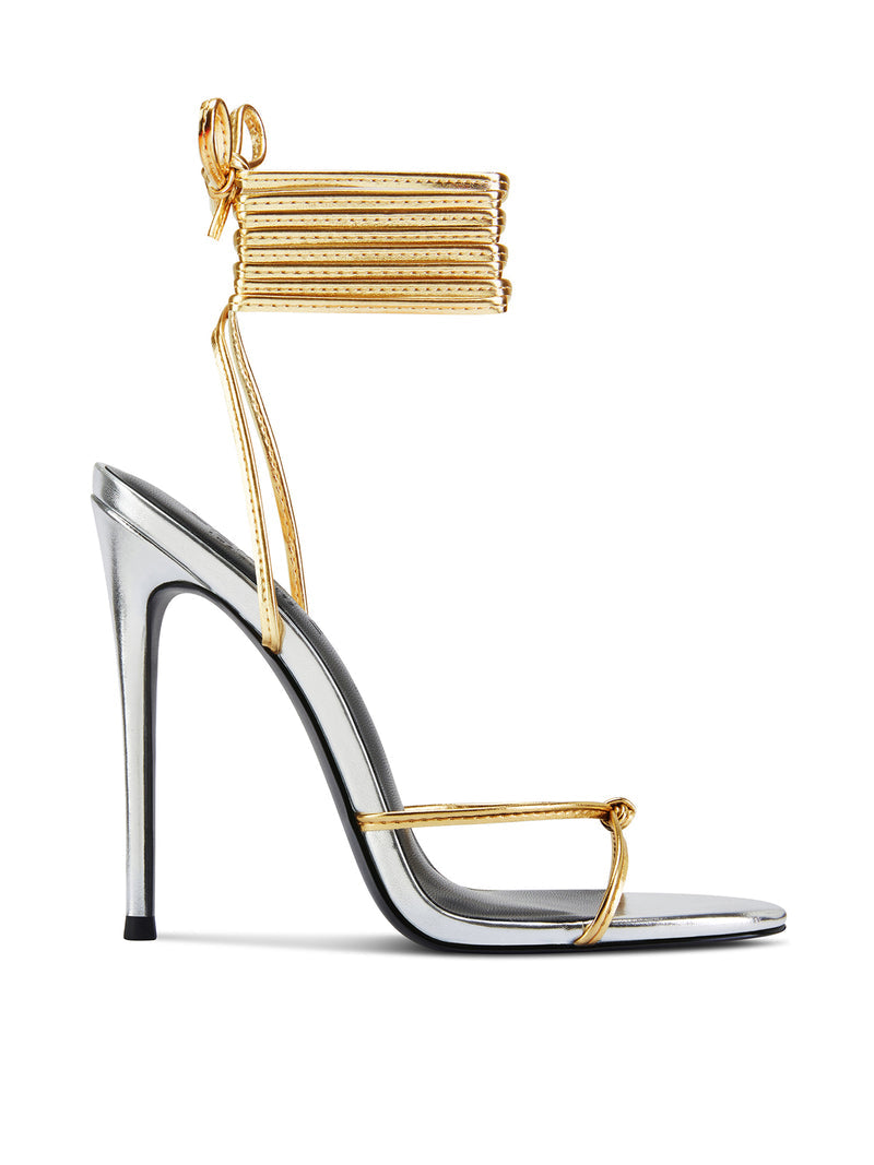 Femme LA Athens Lace Up in Gold/Silver – side profile showing silver metallic body with gold multi-strand lace-up ankle cuff, gold toe strap with knot, and slim stiletto heel