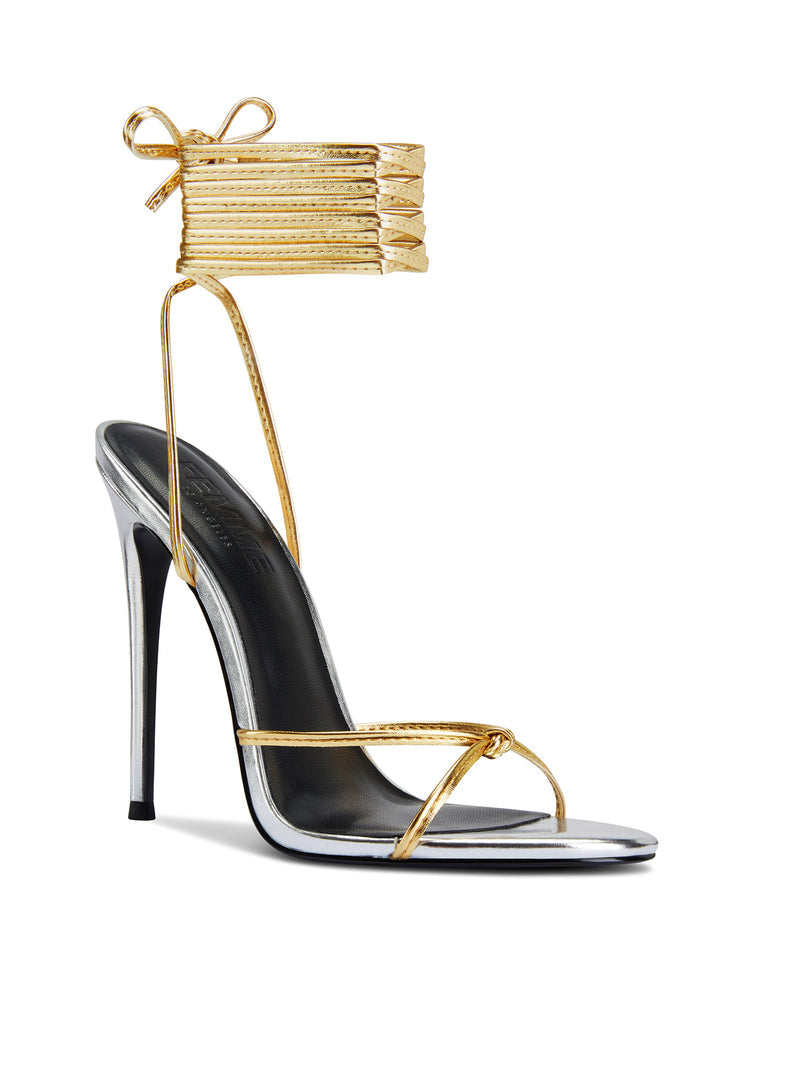 Femme LA Athens Lace Up in Gold/Silver – front three-quarter view showing gold ankle cuff tied in a bow, crossed gold toe straps, and silver metallic toe