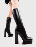 Peak Perfection
  
  Boiling Point Platform Calf Boots in Black faux leather. These platform boots feature on a chunky platform sole, leave them with a lasting impression.Made with eco-friendly materials and 100% cruelty-free, these platform boots are as ethical as they are Perfect!
  
  - Platform Height
  - Heel Height
  - Black Zipper
  - Calf length
  - Chunky Platform sole
  - Shark's teeth grip
  - Square Toe 
  - 100% vegan 
  
  SKU:LMF 2839 - BlackPU