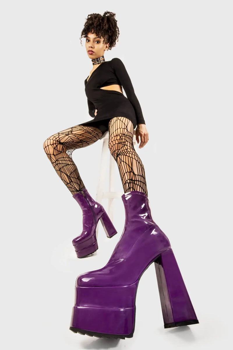 Runway Ready
  
  Cassette Platform Ankle Boots in Purple Patent faux leather. These purple vegan Platform boots feature on our double stack platform sole, sleek and stylish to own your runway! Made with eco-friendly materials and 100% cruelty-free, these platform boots are as ethical as they are runway worthy!
  
  
  - Platform Height
  - Heel Height
  - Purple Zipper 
  - Shark's teeth rubber grip 
  - Chunky platform sole
  - Square Toe
  - 100% vegan 
  
  SKU: LMF 2141 - PurplePAT