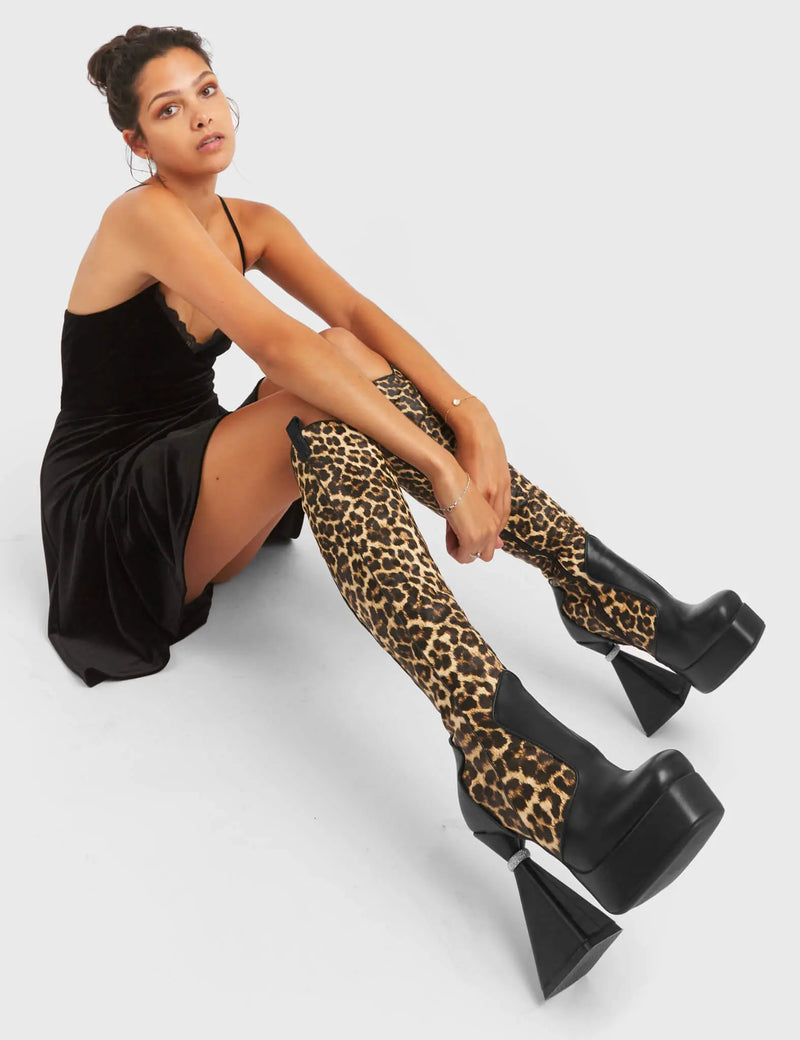 UNFORGETTABLE
  
  Curious Platform Knee High Boots in black and leopard faux leather. These platform boots feature a chic look with a flared heel that includes silver ring detailing on the heel, keeping it nice and classy. These heels also feature a functional zip on the leopard detailed upper. Made with 100% vegan materials. 
  
  - Platform Height
  - Leopard Design
  - Functional Zip
  - Flared Heel
  - Silver Ring Detail
  - Round Toe
  - 100% vegan
  
  SKU: LMF 5442 - BlackPU/Leo