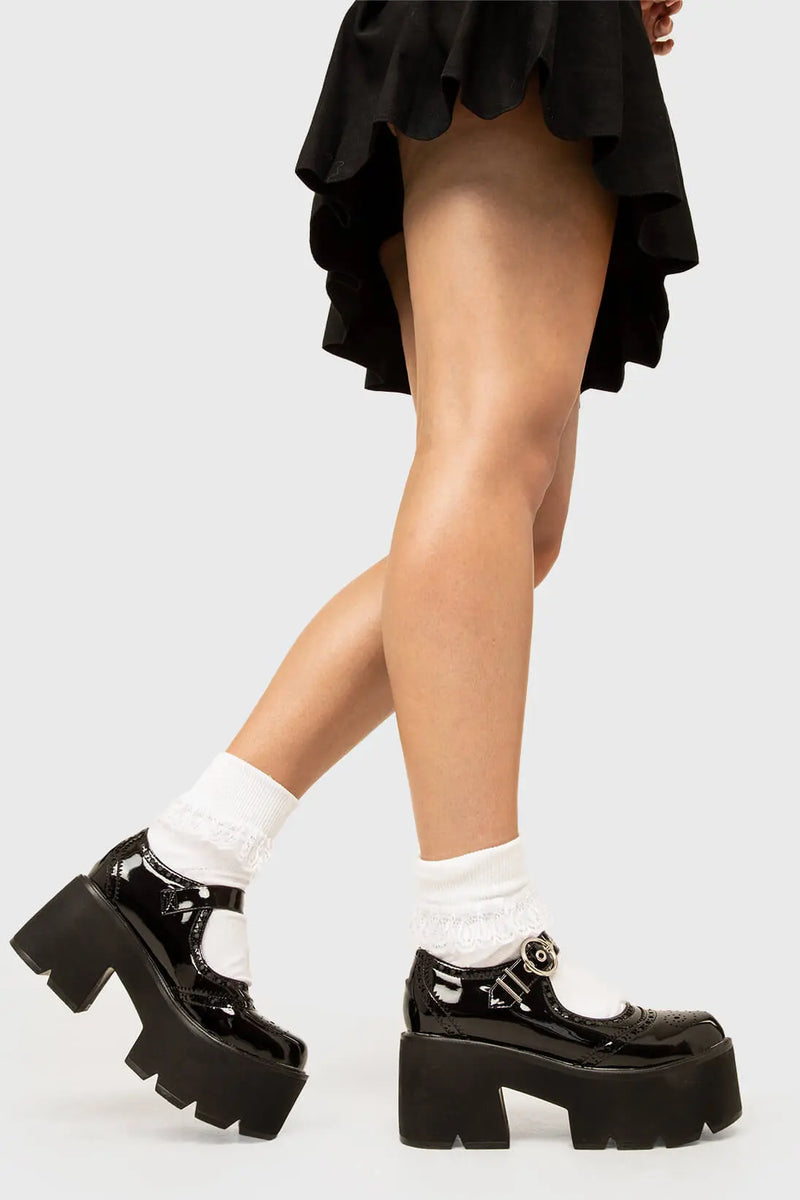 THE SHOEDROBE STAPLE
  
  Dedicated Chunky Mary Jane Shoes in Black Patent. These Mary Janes feature a brogue pattern and a Chunky and comfortable Platform sole. Everyone needs a pairs of Mary Janes! Made with eco-friendly materials and 100% cruelty-free, these Sandals are as ethical as they are cute!
  
  
  - Platform Height: 3 inch
  - Over the foot strap
  - O shaped buckle and silver eyelets
  - Chunky Platform sole
  - Round toe 
  - 100% vegan 
  
  SKU: LMS 400 - BlackPAT