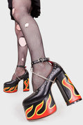 LIFE'S TOO SHORT FOR BORING HEELS
  
  Desire Platform Heels in Black faux leather. These vegan Platform Heels feature a flame print, silver studs and a high Platform sole and high heel, perfect for adding height, edge and glam to any outfit. Made with eco-friendly materials and 100% cruelty-free.
  
  - Platform Height: 2.5 inch
  - Heel Height: 5.5 inch
  - Silver studs & silver hanging chain
  - Adjustable ankle strap 
  - High platform sole
  - Round toe 
  - 100% vegan