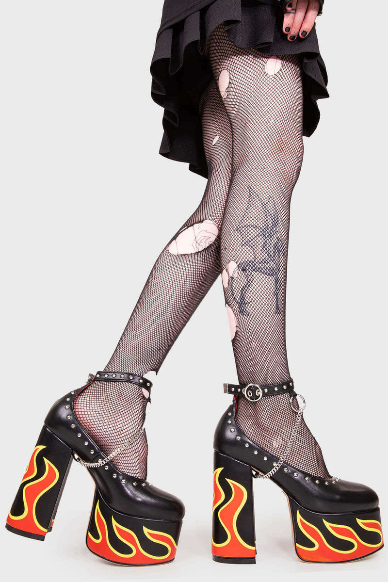 LIFE'S TOO SHORT FOR BORING HEELS
  
  Desire Platform Heels in Black faux leather. These vegan Platform Heels feature a flame print, silver studs and a high Platform sole and high heel, perfect for adding height, edge and glam to any outfit. Made with eco-friendly materials and 100% cruelty-free.
  
  - Platform Height: 2.5 inch
  - Heel Height: 5.5 inch
  - Silver studs & silver hanging chain
  - Adjustable ankle strap 
  - High platform sole
  - Round toe 
  - 100% vegan