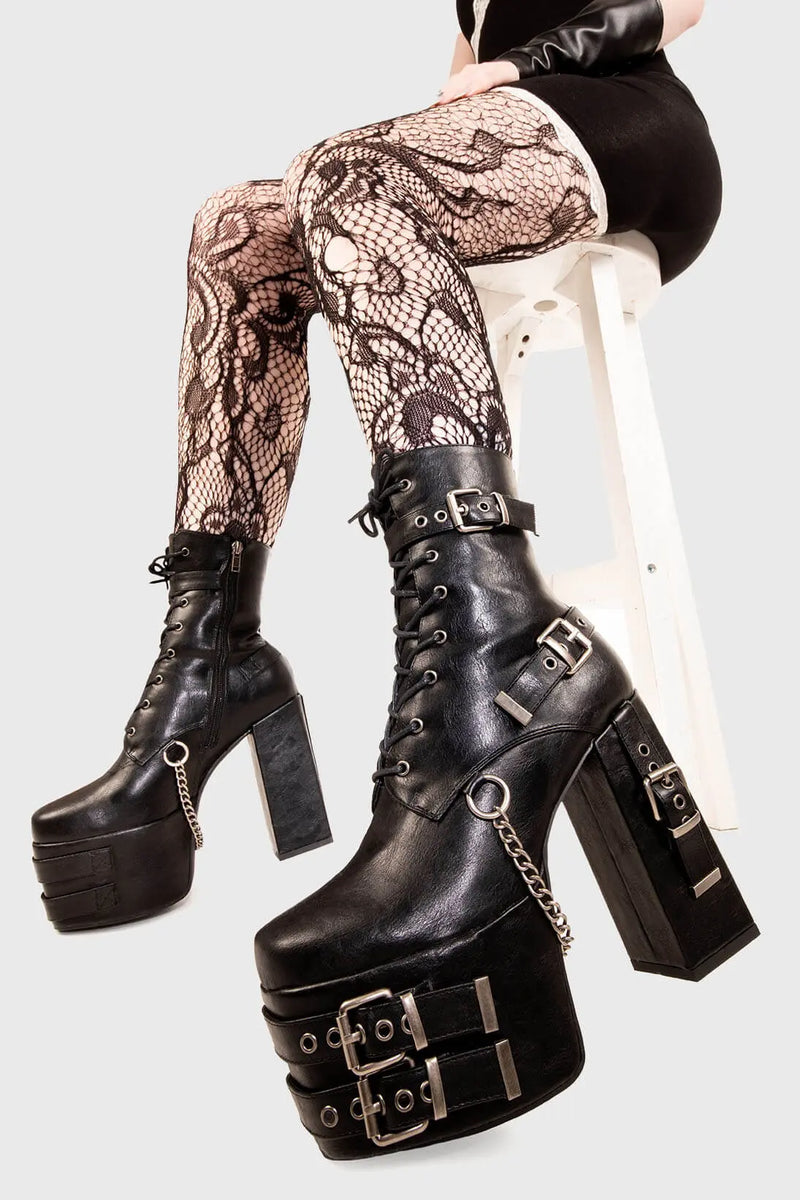 Strapped Up.
  
  Dilligence Chunky Platform Ankle Boots in Black faux leather. These Boots feature lace up detail with two adjustable straps around the ankle and three across the sole and heel. Made with eco-friendly materials and 100% cruelty-free
  
  - Platform Height: 2.5 inch
  - Heel Height: 5.5 inch 
  - Mid ankle length
  - Black zipper 
  - Black strap and silver eyelets
  - Square shaped buckles 
  - Silver chain
  - Chunky Platform sole
  - Round Toe
  - 100% vegan 
  
  SKU: LMF 1862 - BlackPU