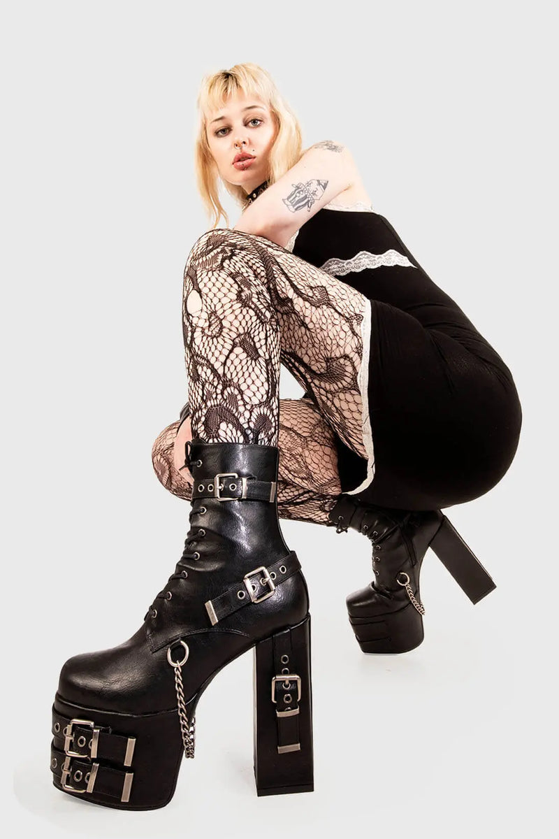 Strapped Up.
  
  Dilligence Chunky Platform Ankle Boots in Black faux leather. These Boots feature lace up detail with two adjustable straps around the ankle and three across the sole and heel. Made with eco-friendly materials and 100% cruelty-free
  
  - Platform Height: 2.5 inch
  - Heel Height: 5.5 inch 
  - Mid ankle length
  - Black zipper 
  - Black strap and silver eyelets
  - Square shaped buckles 
  - Silver chain
  - Chunky Platform sole
  - Round Toe
  - 100% vegan 
  
  SKU: LMF 1862 - BlackPU