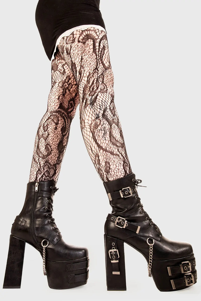 Strapped Up.
  
  Dilligence Chunky Platform Ankle Boots in Black faux leather. These Boots feature lace up detail with two adjustable straps around the ankle and three across the sole and heel. Made with eco-friendly materials and 100% cruelty-free
  
  - Platform Height: 2.5 inch
  - Heel Height: 5.5 inch 
  - Mid ankle length
  - Black zipper 
  - Black strap and silver eyelets
  - Square shaped buckles 
  - Silver chain
  - Chunky Platform sole
  - Round Toe
  - 100% vegan 
  
  SKU: LMF 1862 - BlackPU