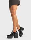 TOO BUSY
  
  Don't Call Chunky Platform Shoes, in Black Faux Leather. These vegan western Boots feature a brogued silhouette and a chunky platform sole, very classy. Also features a adjustable strap with a silver square shaped buckle. Made with eco-friendly materials and 100% cruelty-free, these boots are as ethical as they are edgy!
  
  
  - Chunky Platform
  - Brogued 
  - Sqaure Toe 
  - Adjustable Strap
  - Silver Buckle
  - Silver Eyelets
  - 100% vegan 
  
  SKU: LMF 4089 - BlackPAT