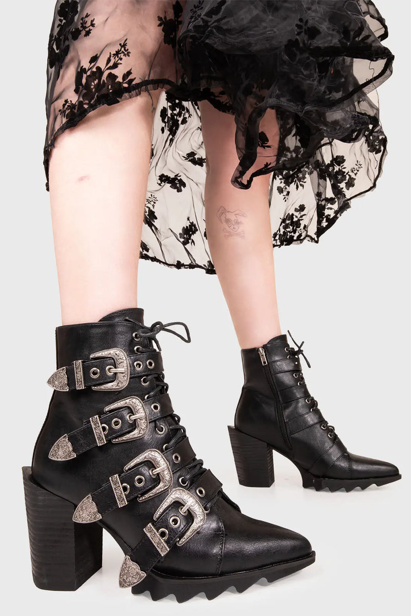 WANNA DUEL?
  
  Don't Even Western Ankle Boots in Black faux leather. These vegan western Boots feature antique buckles and unique solid heel with pointed toe, a true classic. Made with eco-friendly materials and 100% cruelty-free, these boots are as ethical as they are timeless!
  
  
  - Heel Height: 3.8 inch 
  - Low ankle length
  - Black zipper 
  - Lace up
  - Antique buckles
  - Rubber grip sole
  - Pointed toe 
  - 100% vegan 
  
  SKU: LMF 476 - Black PU