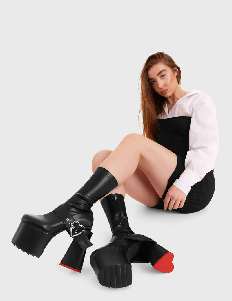 HEART TO HEART
  
  Dream Chaser Platform Ankle Boots in Black faux leather. These platform boots feature silver heart buckle and a heart shaped heel, keeping it nice and classy. Made with eco-friendly materials and 100% cruelty-free, these platform boots are as ethical as they are chic.
  
  - Platform Height
  - Ankle length
  - Silver heart buckle
  - Red sole
  - Shark teeth grip
  - heart shaped heel
  - High Heel
  - 100% vegan 
  
  SKU: LMF 3369 - BlackPU
