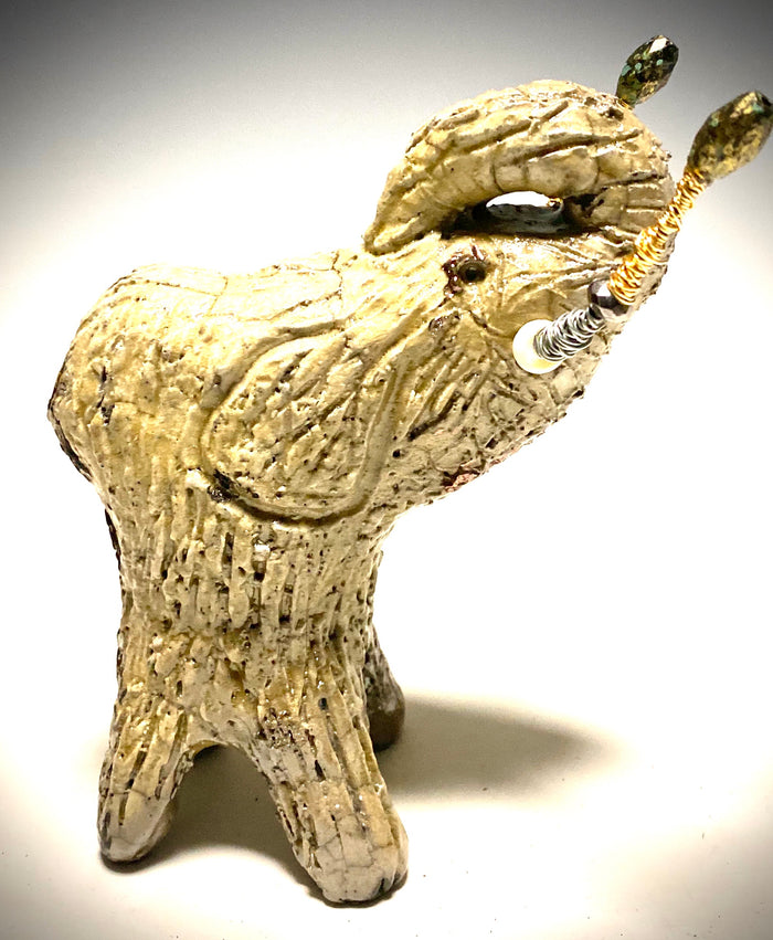 Raku Elephant Have you HERD!!!!!!  Just one of these lovely Raku Fired Elephant will make an excellent gift for your  friend, sorority or for your home’ special place centerpiece.   6" x 3" x 4" 1.3 lbs Beautiful metallic white raku elephant For decorative purposely only
