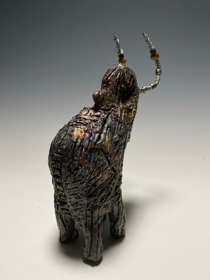 Raku Elephant Have you HERD!!!!!!  Just one of these lovely Raku Fired Elephant will make an excellent gift for your  friend, sorority or for your home’ special place centerpiece.  6" x 4" x 4" 1lbs Wood beaded with  silver tusk Beautiful metallic raku colors For decorative purposely only.