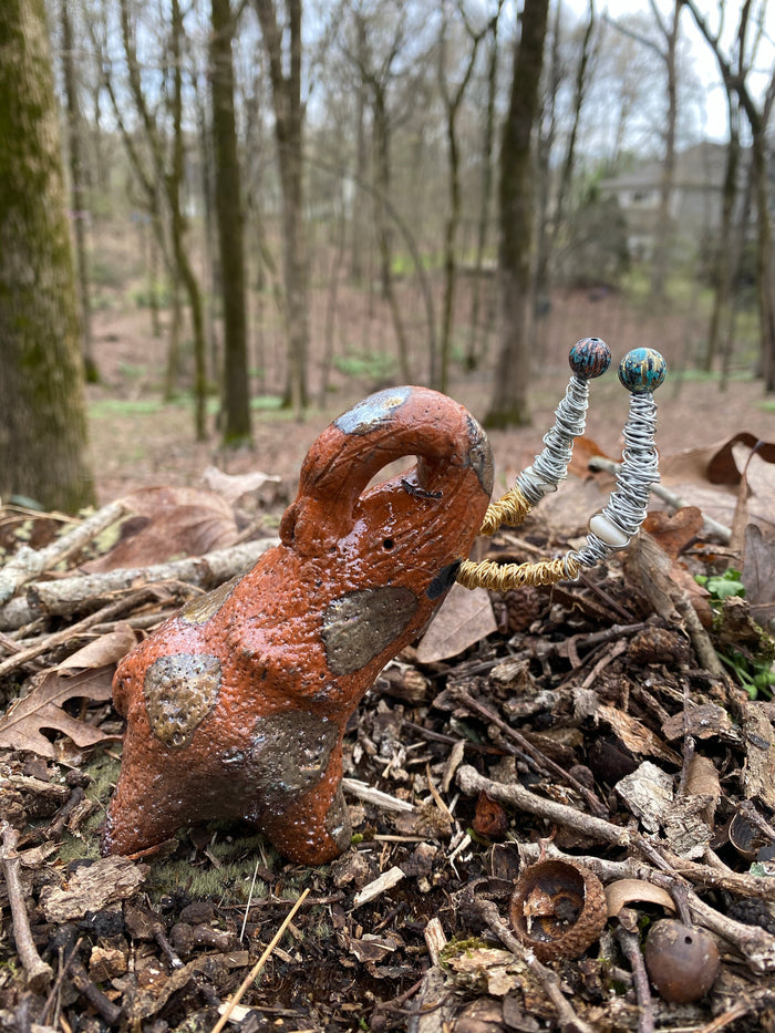 Raku Elephant Have you HERD!!!!!!  Just one of these lovely Raku Fired Elephant will make an excellent gift for your  friend, sorority or for your home’ special place centerpiece.  7" x 4" x 3" 11 ozs. Beautiful metallic gold and orange raku elephant For decorative purposely only.
