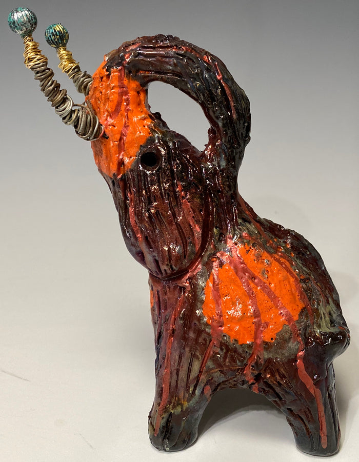 Have you HERD!!!!!!  Just one of these lovely Raku Fired Elephant will make an excellent gift for your  friend, sorority or for your home’ special place centerpiece.   8.5" x 3" x 5" 15 ozs Beautiful two tone copper and orange rust raku elephant. Beaded tribal tusk. For decorative purposely only