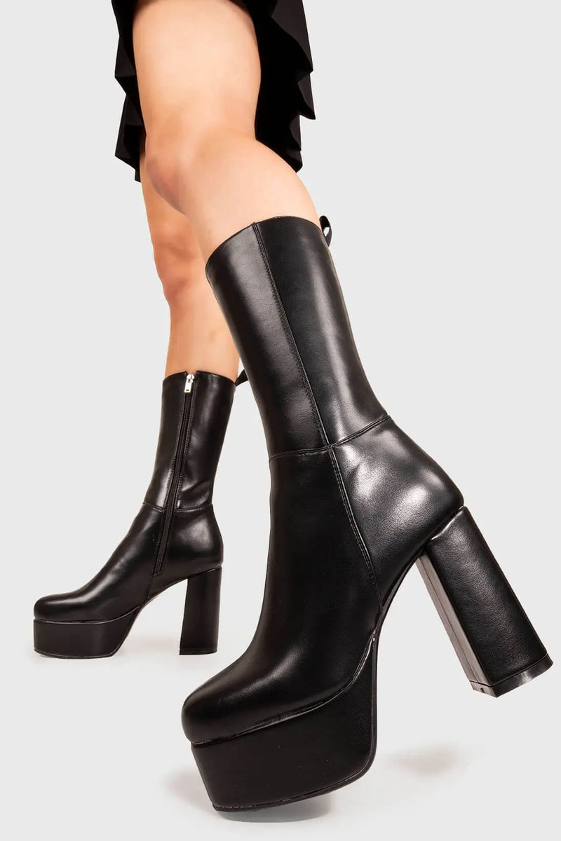 THE TIMELESS ONE
  
  Going Under Platform Calf Boots in Black faux leather. These Black vegan Boots feature an elegant, minimalist design and a Platform sole and heel, perfect for adding height and style to any outfit. Made with eco-friendly materials and 100% cruelty-free, these boots are as ethical as they are stylish.
  
  
  - Platform Height: 1.25 inch
  - Heel Height: 4.2 inch
  - Calf High length
  - Black zipper 
  - Platform sole
  - Round toe 
  - 100% vegan 
  
  SKU: LMF 1209 - BlackPU