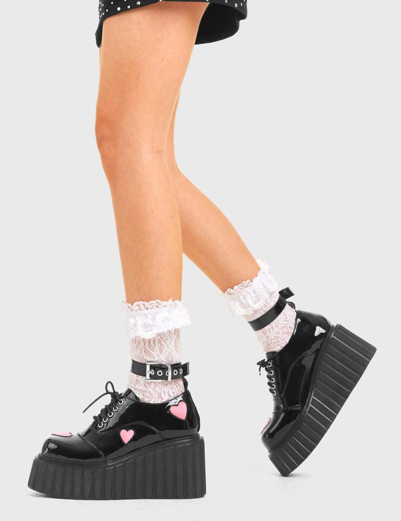 HIGH MOOD Good Day Chunky Platform Creeper Shoes in Black Patent. These vegan shoes feature pink hearts and a adjustable strap, very classy. Made with eco-friendly materials and 100% cruelty-free, these boots are as ethical as they are edgy! - Chunky Platform - Ankle length - Adjustable straps - Silver Buckle - Pink Heart feature - Rounded toe - 100% vegan SKU: LMF 3620 - BlackPAT/PinkHeart