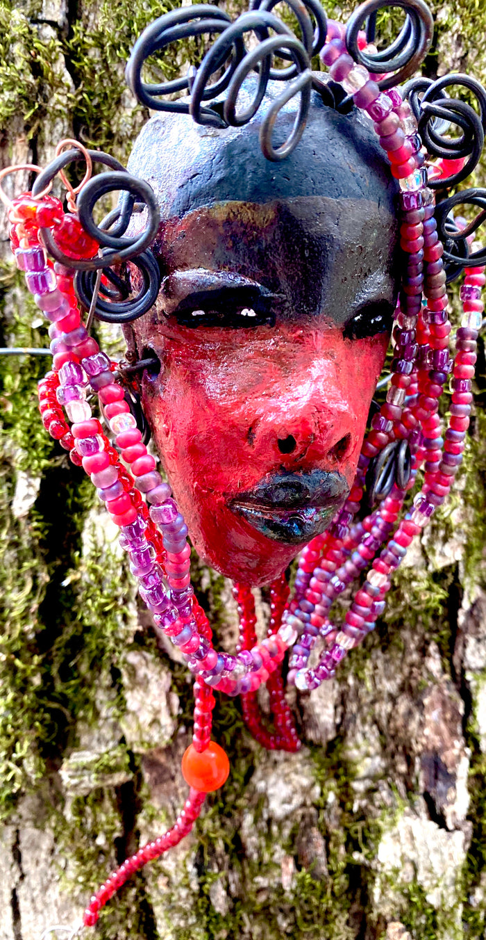 Meet Hariel! I started making art soon after seeing authentic African artwork at the Smithsonian Museum of African Art. I was in total awe. Jafari was inspired by my visit there.   Hariel has a two tone red and dark metallic copper complexion. She  is 6" x 4" and weighs 5 ozs. Hariel has over 4 feet of coiled 16 gauge wire hair and countless red mini beads..