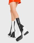 TIME TO DANCE Headturner Platform Calf Boots in Black and white faux leather. These platform boots feature a black and white patch design with a Flared heel, keeping it nice and classy. Made with eco-friendly materials and 100% cruelty-free, these platform boots are as ethical as they are chic. - Platform Height - Calf length - Patch design - Flared heel - High Heel - 100% vegan SKU: LMF 3773 - BlackPU/WhitePU