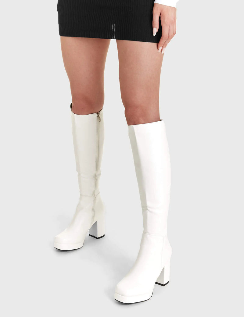 Elegant Entrancers
  
  Humble Platform Knee High Boots in White faux leather. These white Platform Boots feature on our platform sole with gusset detail to the back of the boot, perfect for any occasion. Made with eco-friendly materials and 100% cruelty-free, these platform boots are as ethical as they are Elegant! 
  
  - Platform Height
  - Heel Height
  - Gusset detail
  - Black zip
  - Wide ankle and calf friendly
  - Platform sole
  - Square Toe 
  - 100% vegan 
  
  SKU: LMF 2179 - White