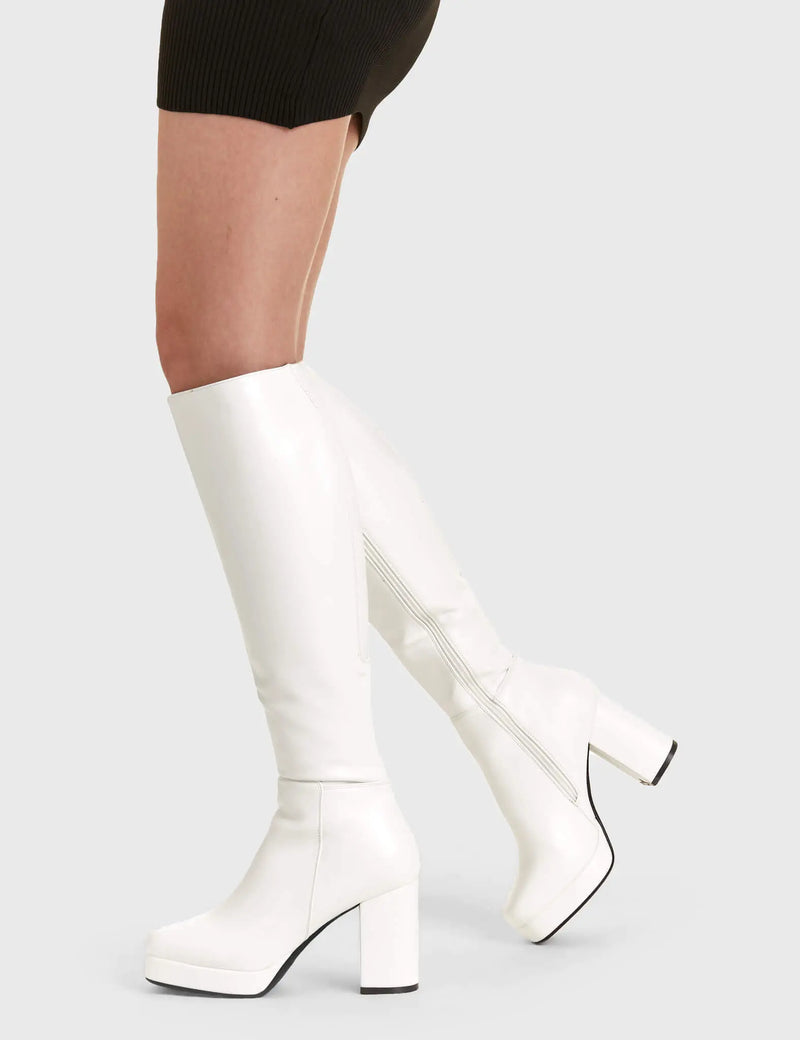 Elegant Entrancers
  
  Humble Platform Knee High Boots in White faux leather. These white Platform Boots feature on our platform sole with gusset detail to the back of the boot, perfect for any occasion. Made with eco-friendly materials and 100% cruelty-free, these platform boots are as ethical as they are Elegant! 
  
  - Platform Height
  - Heel Height
  - Gusset detail
  - Black zip
  - Wide ankle and calf friendly
  - Platform sole
  - Square Toe 
  - 100% vegan 
  
  SKU: LMF 2179 - White