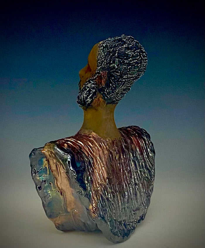 In Memory of  April 4, 1968, Dr. Martin Luther King and the Civil Rights Movement. I Am a Man-2  is a declaration of civil rights, often used as a personal statement and as a declaration of independence against oppression.  I am a Man stands 9" x 7" x 3.5" and weighs 2 lbs. I am a Man wears a colorful metallic blue and copper dashiki. He is bald and bearded. Yes ,,,,,,He is one of few Men found in the Herdew collection!