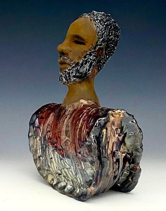 In Memory of  April 4, 1968, Dr. Martin Luther King and the Civil Rights Movement. I Am a Man-2  is a declaration of civil rights, often used as a personal statement and as a declaration of independence against oppression.  I am a Man stands 9" x 7" x 3.5" and weighs 2 lbs. I am a Man wears a colorful metallic blue and copper dashiki. He is bald and bearded. Yes ,,,,,,He is one of few Men found in the Herdew collection!