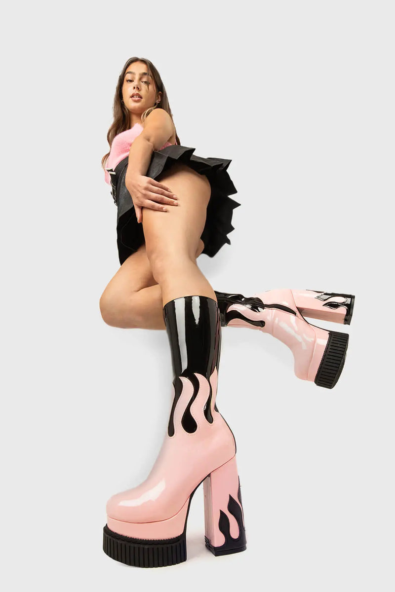 SIZZLING STOMPERS
  
  Ignite Platform Calf Boots in Black Patent. These vegan Platform Boots feature a pink patent flame sole with a black Patent flame on the heel igniting your outfit. Made with eco-friendly materials and 100% cruelty-free, these Boots are as ethical as they are HOT!
  
  - Platform Height: 2 inch
  - Heel Height: 5.5 inch
  - Patent pink flame sole
  - Patent black flame on heel 
  - Platform creeper sole
  - Black Zipper
  - Round toe 
  - 100% vegan 
  
  SKU: LMF 1576 - Black/Pink