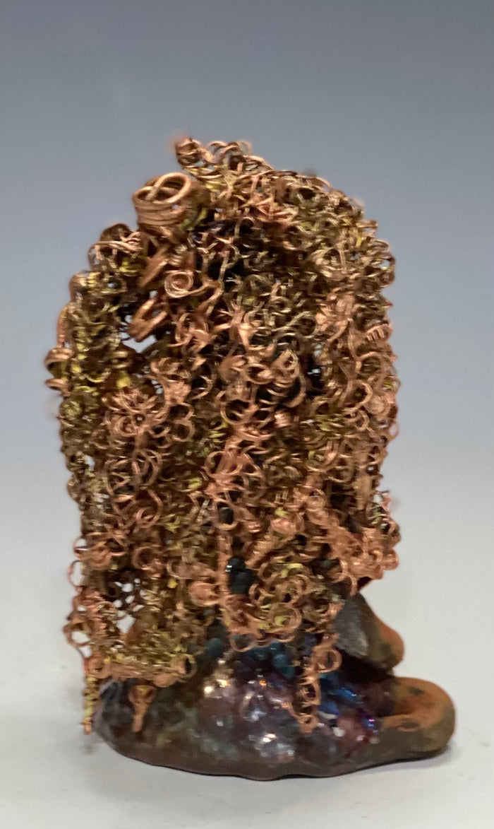 Meet Tiana! Tiana stands 5" x 3.5" x 3.5" and weighs 10 ozs. She has a lovely honey brown complexion. Tiana's dress is  metallic copper. She has her long loving arms resting at her side. " I am really pleased  with Tiana's blue beaded necklace and her new wire hair Find a place in your space for Tiana!