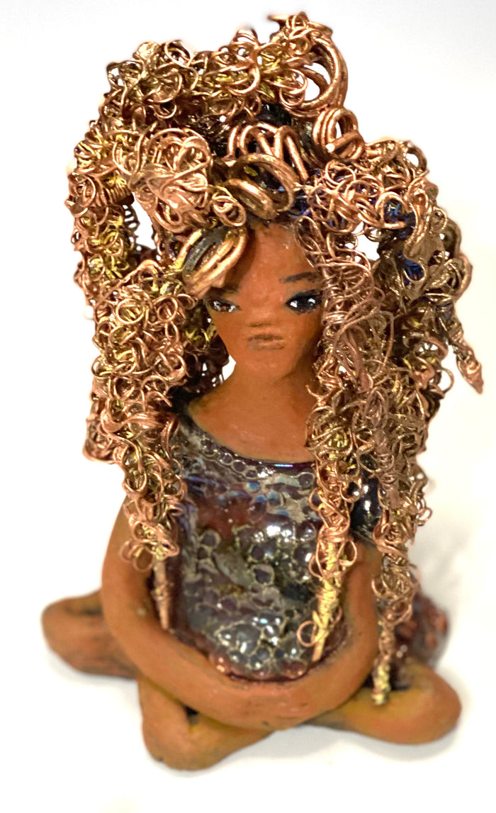 Meet Tiana! Tiana stands 5" x 3.5" x 3.5" and weighs 10 ozs. She has a lovely honey brown complexion. Tiana's dress is  metallic copper. She has her long loving arms resting at her side. " I am really pleased  with Tiana's blue beaded necklace and her new wire hair Find a place in your space for Tiana!