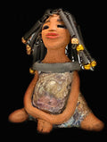 Meet Sadie  Sadie stands 5.5" x 4" x 3" and weighs 8.7 ozs. She wears a lovely glossy  metallic gold dress.. Sadie has over15 feet of coiled wire hair. Sadie appears to sit in a yoga pose. Her long arms rest at her side. Sadie is a great starter piece from the Herdew Collection!