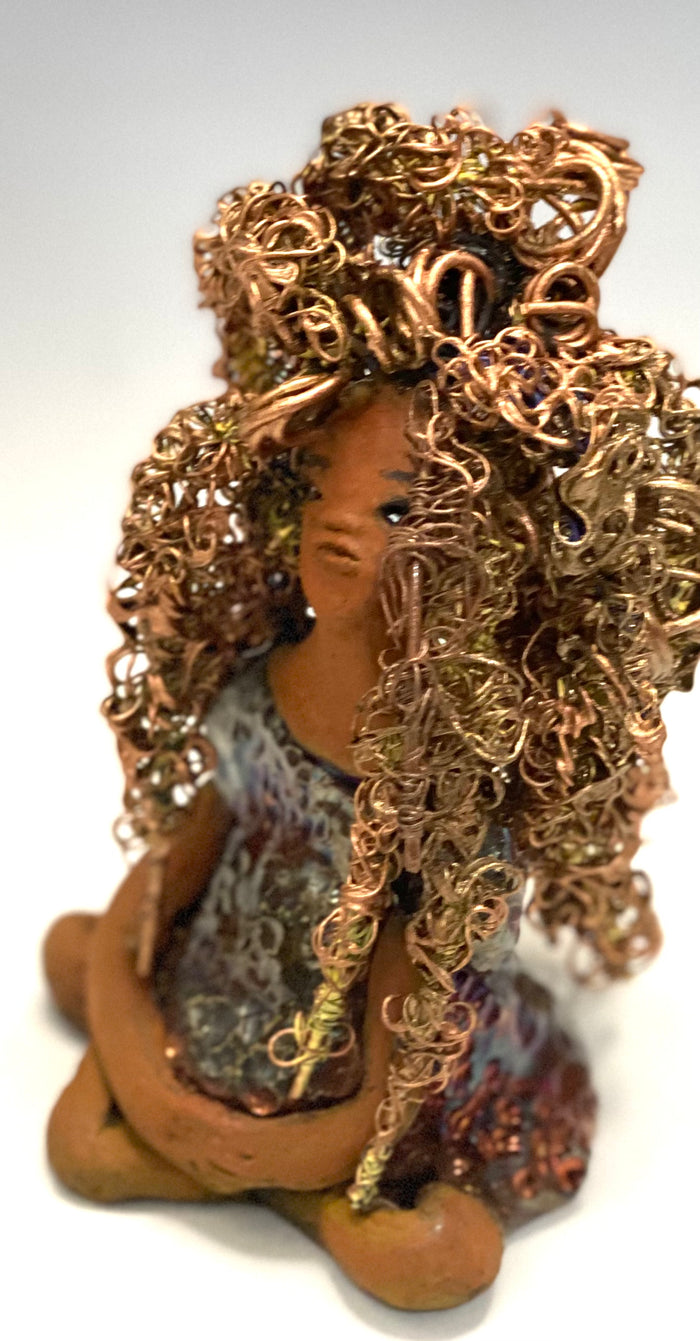 Meet Tiana! Tiana stands 5" x 3.5" x 3.5" and weighs 10 ozs. She has a lovely honey brown complexion. Tiana's dress is  metallic copper. She has her long loving arms resting at her side. " I am really pleased  with Tiana's blue beaded necklace and her new wire hair Find a place in your space for Tiana!