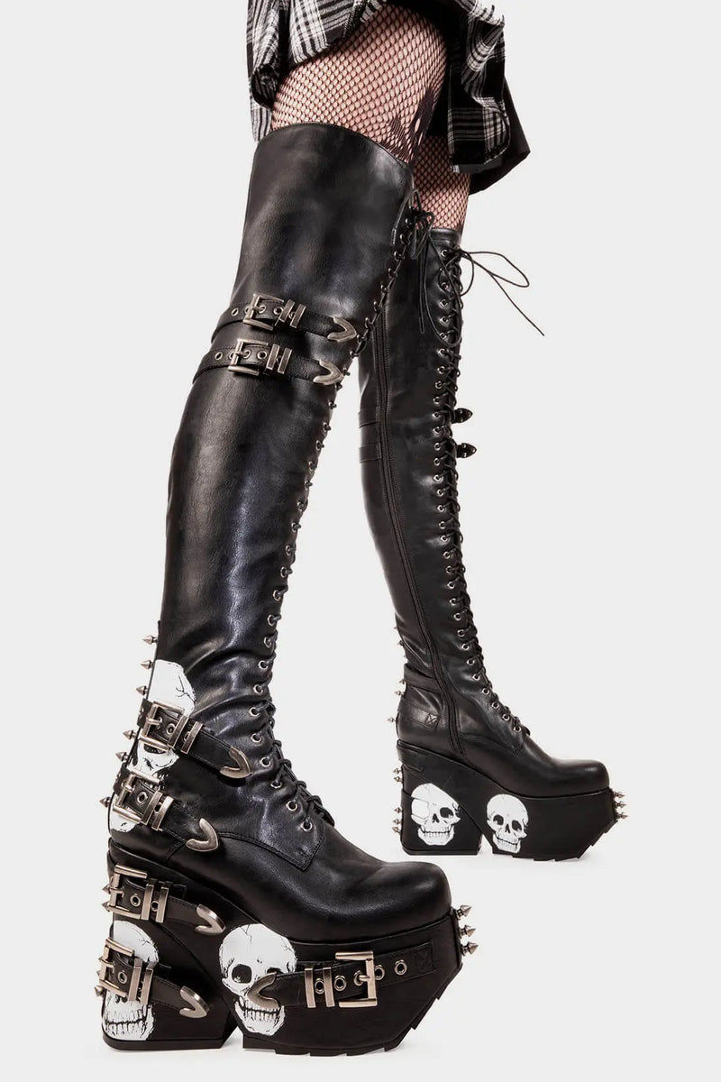 Savage Stompers
  
  Irrational Thoughts Chunky Platform Thigh High Boots in Black faux leather. These black vegan Platform Boots feature our iconic skull print throughout the sole and up the heel with adjustable black lace up detail on our chunky platform sole, stomp with savage.
  
  
  - Platform Height
  - Heel Height 
  - Black Zipper
  - Adjustable black lace up detail
  - Skull print 
  - Silver square shaped buckles with silver eyelets 
  - Silver spiked studs 
  
  
  SKU: LMF 2075 - Black/Skull