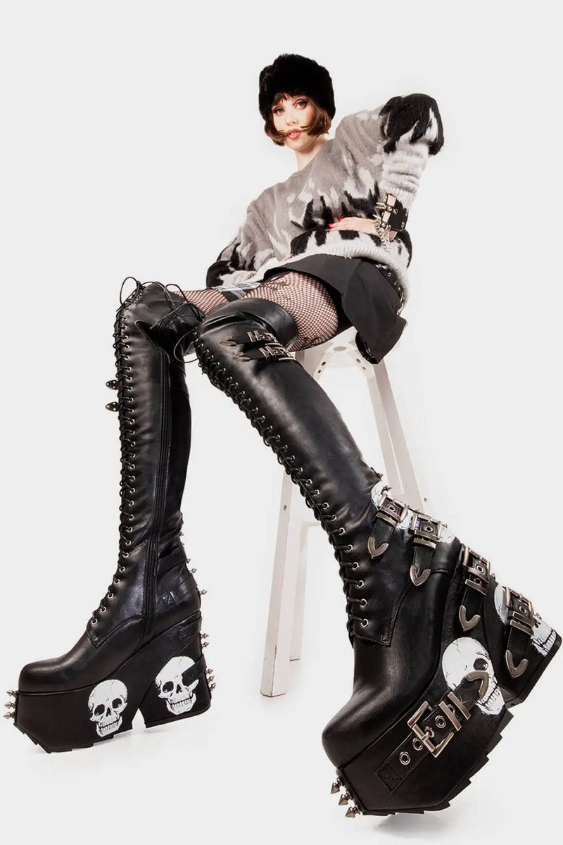 Savage Stompers
  
  Irrational Thoughts Chunky Platform Thigh High Boots in Black faux leather. These black vegan Platform Boots feature our iconic skull print throughout the sole and up the heel with adjustable black lace up detail on our chunky platform sole, stomp with savage.
  
  
  - Platform Height
  - Heel Height 
  - Black Zipper
  - Adjustable black lace up detail
  - Skull print 
  - Silver square shaped buckles with silver eyelets 
  - Silver spiked studs 
  
  
  SKU: LMF 2075 - Black/Skull