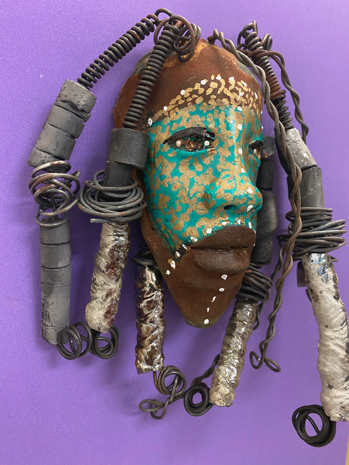 Meet Kanumba! I started making art soon after seeing authentic African artwork at the Smithsonian Museum of African Art. I was in total awe. Kanumba was inspired by my visit there.   Kanumba has an awesome earthy green tribal scarification complexion. He is approximately 8" x 8" and weighs 13 ozs. Kanumba has an handmade textured off white clay and metallic dreadlocks along with twist of coiled 16 gauge wire.