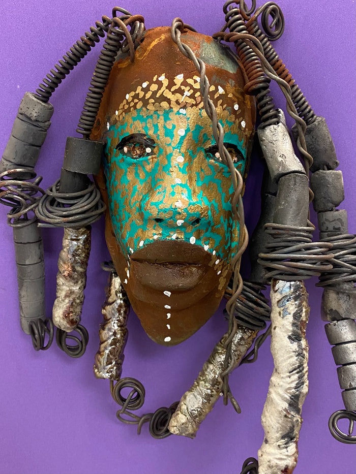 Meet Kanumba! I started making art soon after seeing authentic African artwork at the Smithsonian Museum of African Art. I was in total awe. Kanumba was inspired by my visit there.   Kanumba has an awesome earthy green tribal scarification complexion. He is approximately 8" x 8" and weighs 13 ozs. Kanumba has an handmade textured off white clay and metallic dreadlocks along with twist of coiled 16 gauge wire.